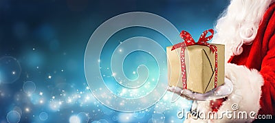 Christmas Gift - Santa Claus Giving Gift Box Stock Photo