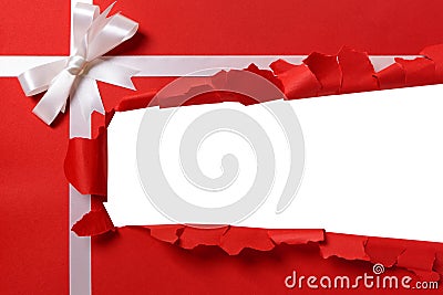 Christmas gift torn open strip, white ribbon bow, red wrapping paper Stock Photo