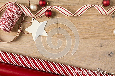 Christmas gift wrapping paper and ribbons supplies on wood background Stock Photo