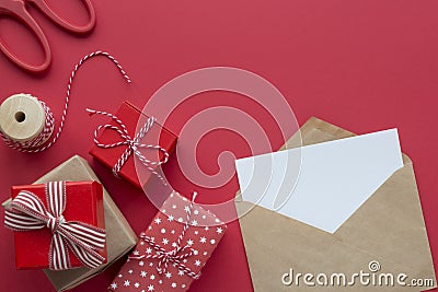 Christmas gifts and envelope for signs on a red background top view Stock Photo