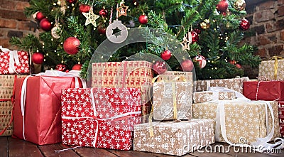 Christmas gifts under the Christmas tree red and wooden toys brick wall. new year 2019 Stock Photo