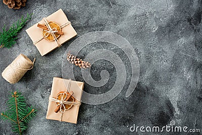 Christmas gifts, winter plants and cones on dark background. Winter composition. Flat lay. Top view Stock Photo