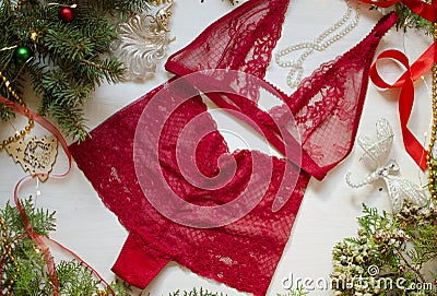 Christmas gilt for women. Red lace lingerie on the decorative Ne Stock Photo