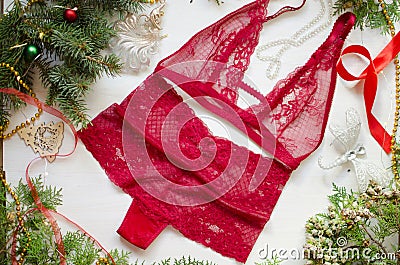 Christmas gilt for women. Red lace lingerie on the decorative Ne Stock Photo