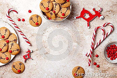 Christmas gingerbread background. Decorated red nosed reindeer cookies with chocolate buttons and melted chocolate. Stock Photo