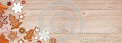 Christmas gingerbread cookies, candy and baking items, corner border banner on a wood background Stock Photo