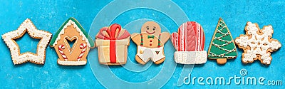 Christmas gingerbread in line on a blue grunge background , border. Various colored gingerbread cookies, banner. Top view, flat Stock Photo