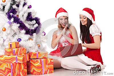 Christmas girlfriends with laptop. Stock Photo