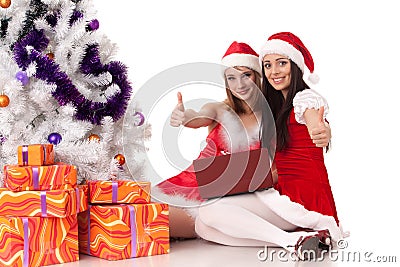 Christmas girlfriends with laptop. Stock Photo