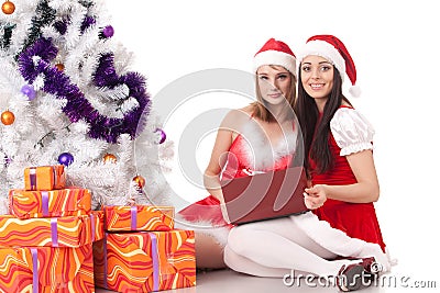 Christmas girlfriends with laptop. Stock Photo