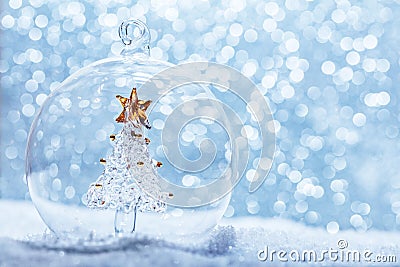 Christmas glass ball with crystal tree inside in snow Stock Photo