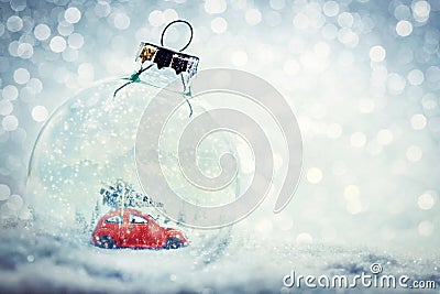 Christmas glass ball in snow with miniature winter world inside Stock Photo