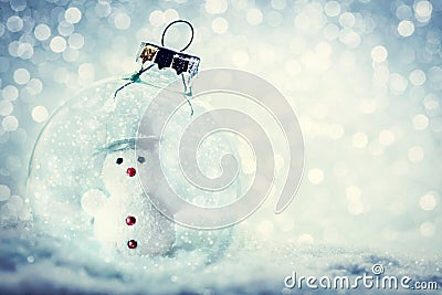 Christmas glass ball with snowman inside. Snow and glitter Stock Photo