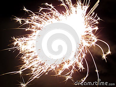 Christmas glittering sparkler. Burning Holiday Party Sparkler in night Stock Photo