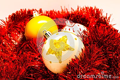 Christmas Globes on red tinsel isolated on white. Handmade decoration. Stock Photo