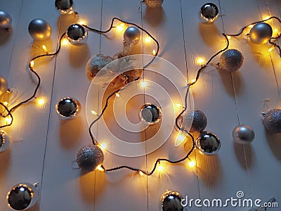 Christmas glowing garland and silver Christmas balls on a white background Stock Photo