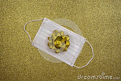 Christmas gold deco baubles on golden background with surgical protective mask. New year on quarantine. Flat lay design. Copy Stock Photo