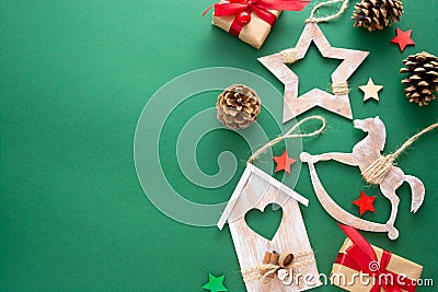 Christmas green background with winter rustic wooden decorations, gift boxes. Copy space, flat lay. Stock Photo