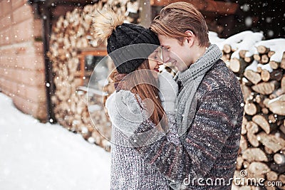 Christmas happy couple in love embrace in snowy winter cold forest, copy space, new year party celebration, holiday and Stock Photo