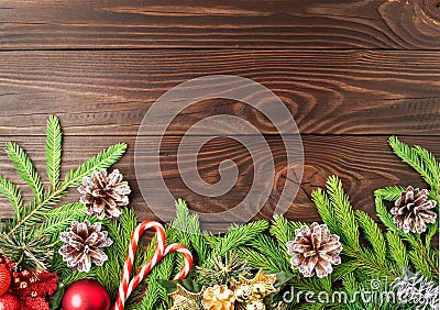 Christmas and Happy New Year dark brown background. Top view, copy space, wooden rustic table, fir branches Stock Photo