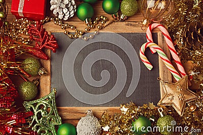 Christmas holiday background with blank chalkboard and Christmas decorations. Border design with copy space in the middle. Top.. Stock Photo