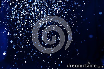 Christmas and holiday background. Blue glowing abstract glitter on black Stock Photo