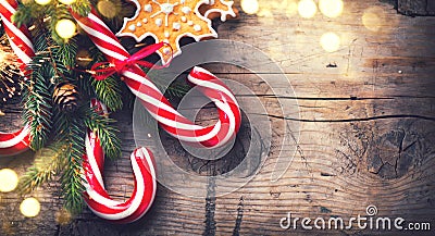 Christmas holiday background with gingerbread cookies, candy cane and evergreens border Stock Photo