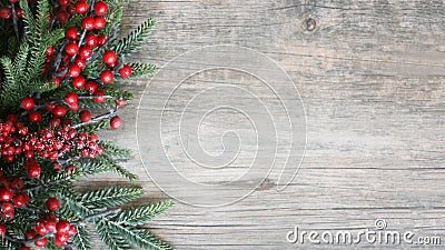 Holiday Evergreen Branches and Berries Over Rustic Wood Background Stock Photo