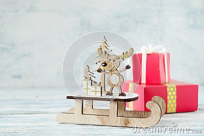 Christmas holiday festive theme with wooden cute reindeer on sled Stock Photo