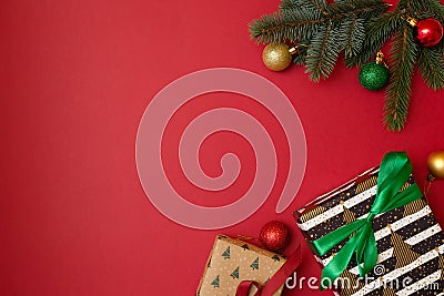 Christmas holidays composition on red background with copy space for your text. Xmas tree branches in the corners, dried oranges, Stock Photo