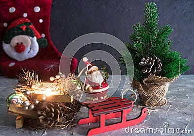 Merry christmas and a happy new year. a Santa Claus toy, a burning candle and a sleigh. Christmas Holidays. set of Christmas ornam Stock Photo