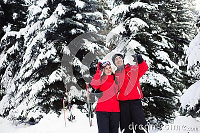 Christmas holidays in the winter forest. Portrait of lovers with skis enjoys winter in the park. Stock Photo