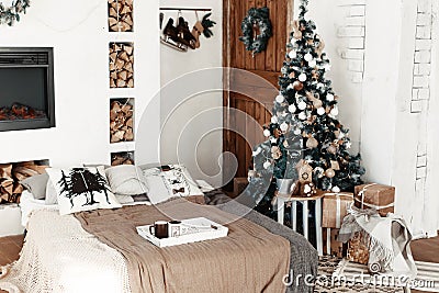 Christmas home interior with tree and fireplace. living room in country house decorated with lights and candles Stock Photo