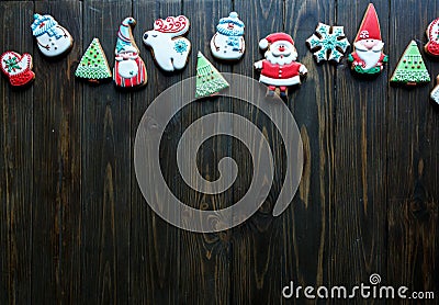 Christmas homemade gingerbread cookies, spices on the plate on dark wooden background among Christmas presents Stock Photo