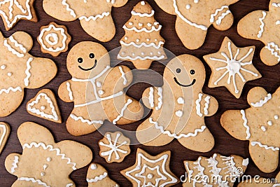 Christmas homemade gingerbread couple, firs, stars cookies over wooden background Stock Photo