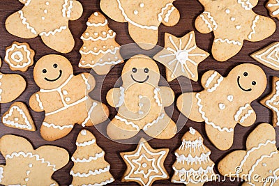 Christmas homemade gingerbread men, firs, stars cookies over wooden background Stock Photo