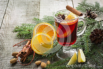 Christmas hot mulled wine with cinnamon, orange and christmas tree on board. Winter tradition drink. Stock Photo