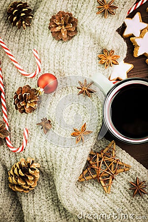 Christmas hot steaming cup of glint wine with spices, anise, cookies in a shape of star, red candies, pepper, fir cones and gray Stock Photo