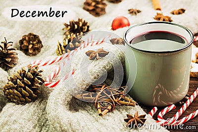 Christmas hot steaming cup of glint wine with spices, cinnamon, anise, cookies in a shape of star, red candies, fir cones, pepper Stock Photo