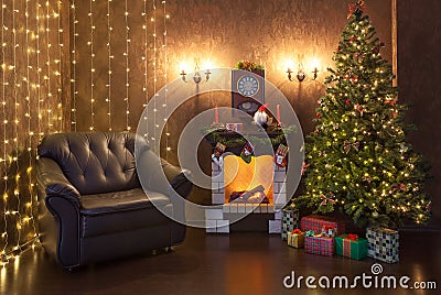 Christmas interior of the house in the evening. Christmas tree decorated with lights, fire burns in the fireplace. Stock Photo