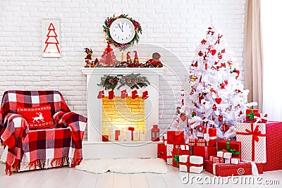 Christmas interior in red and white colors with tree and fireplace. Stock Photo