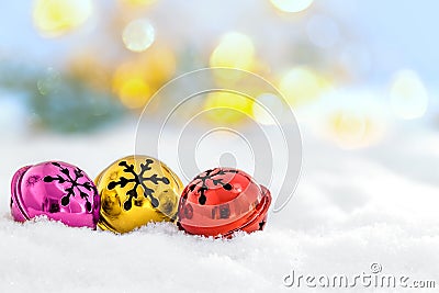 Christmas jingle bells in the snow and defocused lights Stock Photo