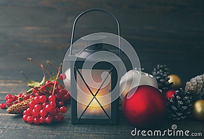 Christmas lamp and glass spheres with cones on a wooden background. Stock Photo