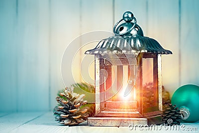 Christmas lamp with pinecone and ball on wooden board Stock Photo