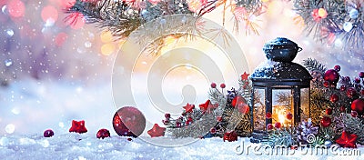 Christmas Lantern On Snow With Fir Branch in the Sunlight Stock Photo