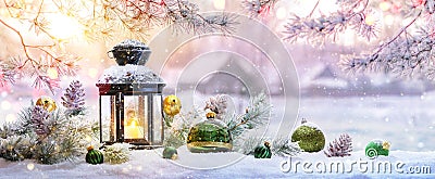 Christmas Lantern On Snow With Fir Branch in the Sunlight Stock Photo