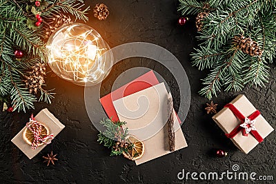 Christmas letter for Santa on dark background with gifts, fir branches, pine cones, glowing ball. Xmas and Happy New Year theme. Stock Photo