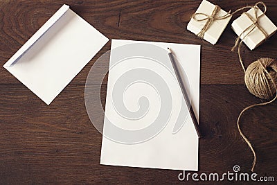 Christmas letter writing on white paper on wooden background with decorations. Christmas border design on the wooden background Stock Photo