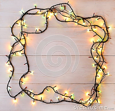 Christmas lights background. Holiday glowing garland on light wo Stock Photo