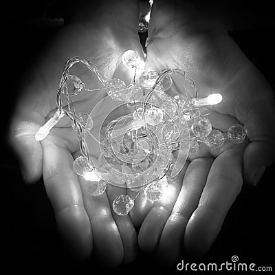 Christmas lights in hand Stock Photo